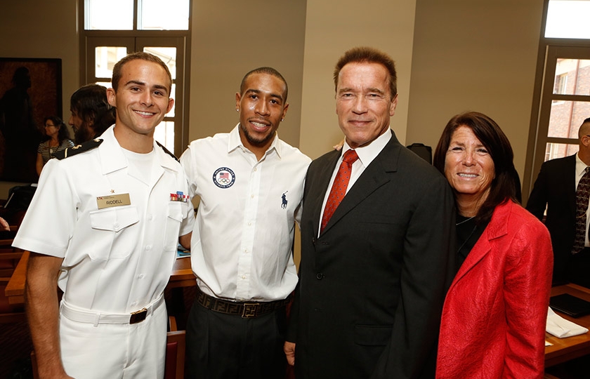 NROTC Midshipman Greg Riddell, Olympic medalist Bryshon Nellum, Governor Arnold Schwarzenegger, and Institute Global Director Bonnie Reiss celebrate the launch of the institute