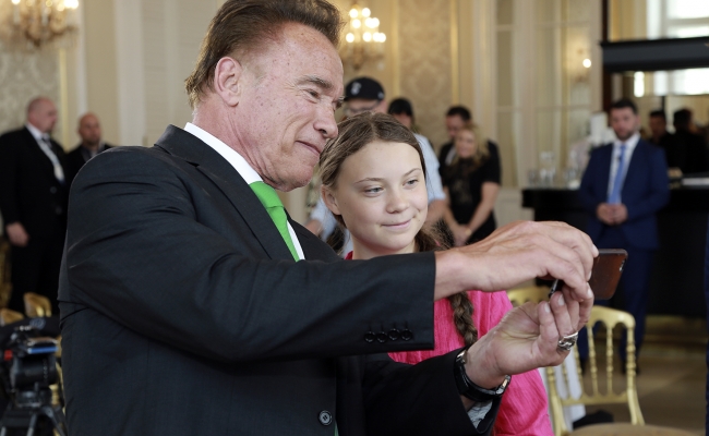 Governor Arnold Schwarzenegger takes a selfie with environmental activist Greta Thunberg.