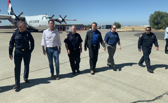 Gov. Gavin Newsom and Gov. Arnold Schwarzenegger Tour Cal Fire Equipment At McClellan Airport