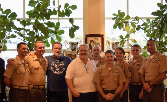 Governor Schwarzenegger and John Milius take a picture with leaders from the United States Marine Corps.